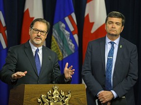 Paul Whittaker (left, President & CEO, Alberta Forest Products Association) and Oneil Carlier, (right, Alberta Minister of Agriculture & Forestry), respond to the softwood lumber dispute with the United States, at the Alberta Legislature in Edmonton on April 25, 2017.