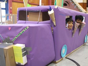 Priyank LNU, left, and Abishek Vijay Vinod Sankari peek out from inside of an ice cream truck made out of cardboard boxes. The students took part in Not a Box Day at Ellerslie Campus at 521 66 St. SW in Edmonton on Wednesday, April 19, 2017.