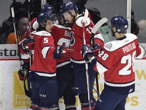 Forward Tyler Wong (No.5) and defenceman Brady Pouteau (No. 28) of Lethbridge Hurricanes celebrate a goal with teammates against the Regina Pats in second period of Game 2 at the Brandt Centre in Regina on April 21, 2017. The Hurricanes won 3-1.