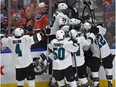 San Jose Sharks swamp Melker Karlsson (68) after he scores in overtime against the Edmonton Oilers during game one of the first round of NHL playoff action at Rogers Place in Edmonton, April 12, 2017.