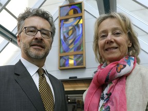 Scott Watson, left, and sister Catherine Watson donated the stained-glass window in the background to the Grey Nuns Hospital in southeast Edmonton, where it was unveiled in the front foyer of the hospital on Wednesday, April 12, 2017. The window was salvaged from the former Knox Metropolitan United Church.