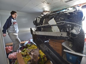 Standing on his bed, Kyle Roach looks at a pickup truck that crashed into his basement suite almost landing on him while he was sleeping around 8 a.m. on April 30, 2017.