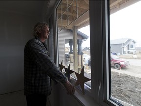 Steve Menard has been rebuilding his house in Fort McMurray which he lost in the wildfire, with the help of his stepson.  Greg  Southam / Postmedia