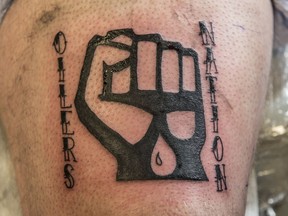 Tattoo artist Jessie Jones inks customer and Edmonton Oilers super-fan Darcy Niedzielski with an Oilers Nation logo at Shambhala Tattoos in Old Strathcona on April 26,  2017.
