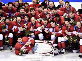 Team Canada poses for a team photo after defeating Sweden to win the gold medal at the 2014 Sochi Winter Olympics in Sochi, Russia on Sunday, February 23, 2014.