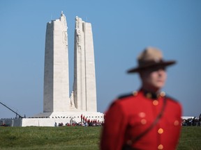 VIMY, FRANCE - APRIL 09: A member of the Royal Canadian Mounted Police stands in front of the Canadian National Vimy Memorial on April 9, 2017 in Vimy, France.