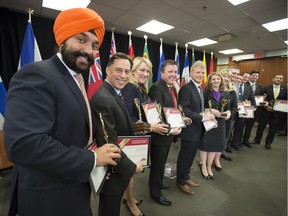 Innovation Minister Navdeep Bains, left, and  Ontario Economic Development Minister Brad Duguid stand with provincial politicians as the completed Canadian Free Trade Agreement is released at Toronto's Ontario Investment and Trade Centre on Friday April 7, 2017.