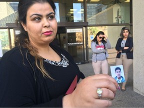 Sarah Hamza holds up a photo of her brother Raad Hamza outside the Edmonton Law Courts. Kyle Ashton was convicted of manslaughter for killing Raad Hamza.
