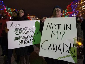 Edmontonians take part in a vigil in response to a deadly shooting at a Quebec City mosque, at the Alberta Legislature in Edmonton, Monday Jan. 30, 2017.