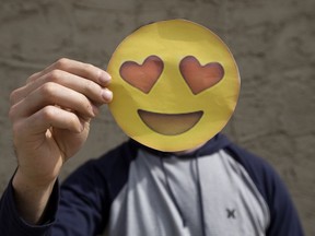 MacEwan University student Darcy Raymond holds an emoji as he poses for a photo at his home in Stony Plain Thursday May 11, 2017. David Bloom