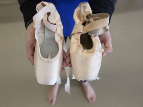 Citie Ballet dancer Kylee Hart displays a new ballet shoe, left, beside an old ballet shoe.