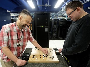 University of Alberta computing science professors Ryan Hayward (left) and Martin Muller play a game of Go in a computer server room at the University of Alberta, in Edmonton Thursday May 18, 2017.