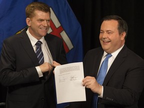 Wildrose Party leader Brian Jean (left) and Alberta PC leader Jason Kenney announce that they have reached a deal to merge the parties and create the United Conservative Party, during a press conference in Edmonton Thursday May 18, 2017.