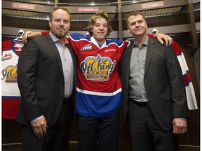 Edmonton Oil Kings Head Coach Steve Hamilton, left, first-round draft pick Jake Neighbours, centre, and General Manager Randy Hansch pose for a photo in the Oil Kings' dressing room in Rogers Place, in Edmonton Thursday May 25, 2017.