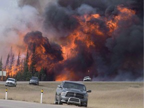 A wild fire rips through the forest 16 kilometres south of Fort McMurray, Alta., on highway 63 on May 7, 2016.