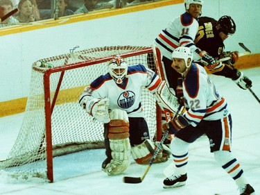 From left, Edmonton Oilers goalie Grant Fuhr and defenceman Charlie Huddy stand guard in from of the net while centre Mark Messier checks Boston Bruins forward Keith Crowder on May 26, 1988, during Game 4 of the Stanley Cup final at Northlands Coliseum.