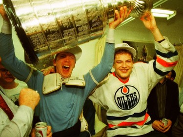 Edmonton Oilers forwards Jari Kurri, left, and Esa Tikkanen hold the Stanley Cup in the team's dressing room on May 26, 1988, at Northlands Coliseum after they beat the Boston Bruins 6-3 in Game 4 of the final to win the league title.