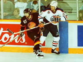Vancouver Canucks centre Cliff Ronning, left, and Edmonton Oilers winger Petr Klima during Game 4 of the Smythe Division final on May 8, 1992, at Northlands Coliseum.