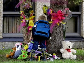 A memorial outside St. Patrick Catholic School in Camrose, Alta., continues to grow in size on Wednesday May 17, 2017. Callie Campbell, a resident of Camrose, was found dead with her father in Red Deer on Sunday, May 14, 2017.