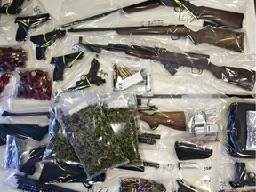 Some of the drugs and weapons that were seized from members of the Warlocks Motorcycle Club are seen at ALERT Headquarters in Edmonton on March 27, 2014. A total of eight people were arrested.