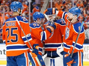 Darnell Nurse, Ryan Nugent-Hopkins and Adam Larsson of the Edmonton Oilers congratulate goalie Cam Talbot on a 7-1 victory against the Anaheim Ducks in Game 6 of the Western Conference semifinal during the 2017 NHL Stanley Cup playoffs at Rogers Place on May 7, 2017 in Edmonton.