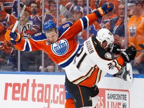 EDMONTON, AB - MAY 7:  Griffin Reinhart #8 of the Edmonton Oilers hits Chris Wagner #21 of the Anaheim Ducks in Game Six of the Western Conference Second Round during the 2017 NHL Stanley Cup Playoffs at Rogers Place on May 7, 2017 in Edmonton, Alberta, Canada.