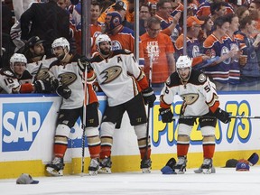 Anaheim Ducks' Andrew Cogliano (7), Ryan Kesler (17) and Nic Kerdiles (58) wait for the hats to be cleaned up after Edmonton Oilers' Leon Draisaitl (29) scored a hat trick during the second period in game six of a second-round NHL hockey Stanley Cup playoff series in Edmonton on May 7, 2017.