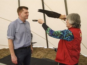 Alberta Wildrose Leader Brian Jean is cleansed by SkyBlue Morin during an anniversary event of the wildfires in Fort McMurray, Alta., on Wednesday, May 3, 2017.