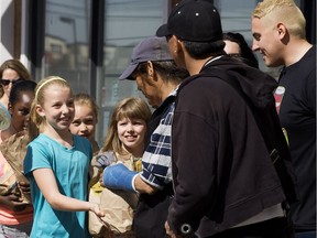 Students from St. Paul Catholic Elementary School hand out care packages to the homeless and less fortunate in downtown Edmonton on May 11, 2017.