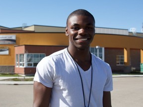 Claude Ngwa, a 17-year-old student standing in front of Mother Margaret Mary High School in Edmonton on Thursday, May 4, 2017, recently became the head coach of his school's track and field team.