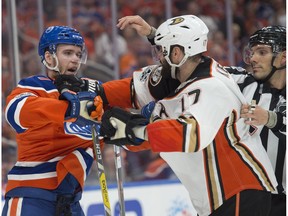 Connor McDavid (97) of the Edmonton Oilers, takes a shot from Ryan Kesler of the Anaheim Duck in Game 6 in the second round of NHL playoffs at Rogers Place on May 7, 2017. Photo by Shaughn Butts / Postmedia