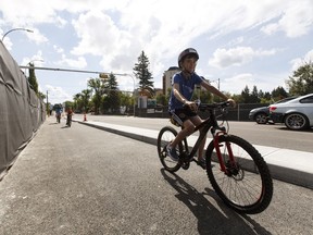 Cyclists cross the 102 Avenue Bridge as it opens in Edmonton, on Friday, July 15, 2016.
