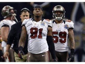 In this Dec. 16, 2012, file photo, Tampa Bay Buccaneers defensive end Da'Quan Bowers (91) walks off the field during a game in New Orleans. (AP Photo)