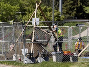 Crews conduct an archeological dig in the median of River Valley Road near the Groat Bridge in Edmonton Tuesday, May 23, 2017.
