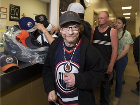 Douglas Newbury gets a hat Monday, May 8, 2017, from a batch dropped off at the Hope Mission after hats were thrown on the ice following Leon Draisaitl's hat-trick goal against the Anaheim Ducks in Game 6.