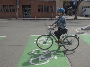 Lesley Vaage rides a half-block section of the new Bike Network on 106 Street. City Councillor Ben Henderson provided an update on the progress of the Downtown Bike Network, including the adaptable design, installation and timelines on May 10, 2017.