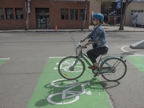 Lesley Vaage rides a half block section of the new Bike Network on 106 Street. City Councilor Ben Henderson provided an update on the progress of the Downtown Bike Network, including the adaptable design, installation and timelines on May 10, 2017.