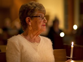Jane Orydzuk holds a candle during the Victims of Homicide Support Society annual memorial for homicide victims at the Strathearn United Church on December 11, 2014. File photo.
