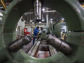 Machinist Victor Bhachu works on a lathe at Universe Machine, an Edmonton manufacturing company that marked its 50th anniversary in 2015, in Edmonton on Tuesday Dec. 15, 2015. File photo.