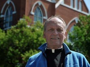 Father Jim Holland stands in front of Sacred Heart Church of the First Peoples in Edmonton Ab on Wednesday, July 11, 2012.