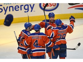Edmonton Oilers Leon Draisaitl (29) celebrates his hat trick goal with Milan Lucic (27), Mark Letestu (55) and Kris Russell (4) as caps start to rain down from the fans, against the Anaheim Ducks during NHL playoff action at Rogers Place in Edmonton, May 7, 2017. Ed Kaiser/Postmedia (Edmonton Journal story by Jim Matheson)
