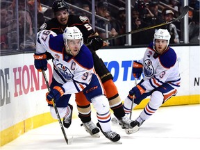 Connor McDavid of the Edmonton Oilers skates away from Shea Theodore of the Anaheim Ducks as Drake Caggiula looks on during the first overtime in Game 5 of their Stanley Cup playoff series on May 5, 2017.