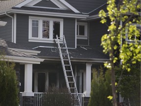 Firefighters clean up after putting a fire out at 361 McGrath Boulevard on Monday May 22, 2017, in Edmonton.