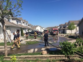 Firefighters respond to a Tuesday morning fire at a row of townhouses at Edwards Drive SW in south Edmonton.
