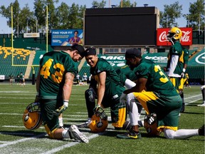 From left, Neil King, Kenny Ladler and Josh Woodman share a laugh during Edmonton Eskimos training camp at Commonwealth Stadium in Edmonton on May 29, 2017.