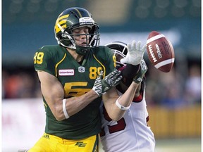 Calgary Stampeders Jamar Wall (29) blocks the football on Edmonton Eskimos Chris Getzlaf (89) during second half CFL action in Edmonton, Alta., on Saturday September 10, 2016. Free agent slotback Getzlaf re-signed with the Edmonton Eskimos on Friday.