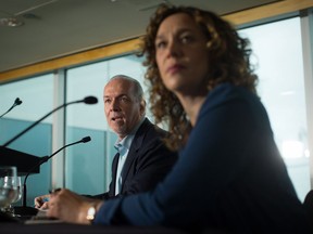 NDP Leader John Horgan, back, and Tzeporah Berman, who was on B.C.'s Climate Leadership Team, listen during a town hall campaign stop in Vancouver, B.C., on Monday May 1, 2017. A provincial election will be held on May 9.