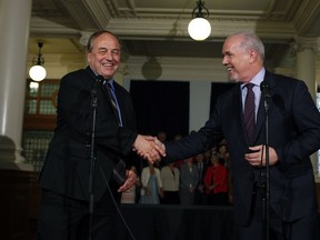 B.C. NDP Leader John Horgan and B.C. Green Party Leader Andrew Weaver shake hands after signing an agreement on creating a stable minority government during a press conference in the Hall of Honour at Legislature in Victoria, B.C., on Tuesday, May 30, 2017.