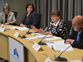 Justice Myra Bielby (2nd right), Chair of the Electoral Boundaries Commission outlined the recommendations for changes to the boundaries and names of some of the electoral divisions or constituencies for Alberta at a news conference in Edmonton, May 25, 2017.