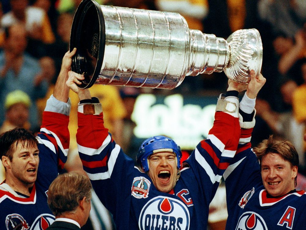 Edmonton Oilers team captain Wayne Gretzky, right, and Mark Messier hold up  the Stanley Cup trophy following the team's 6-3 win over the Boston Bruins  in the Stanley Cup hockey finals in